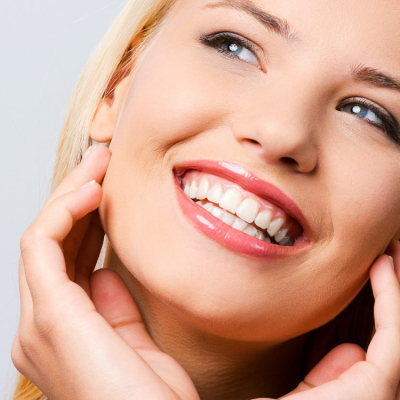Female dental patient smiling during exam at Southcentre Tower Dental in Calgary SE